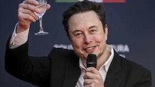 Elon Musk raises a glass as he speaks at a political convention organized by Fratelli d'Italia in Rome, Italy.