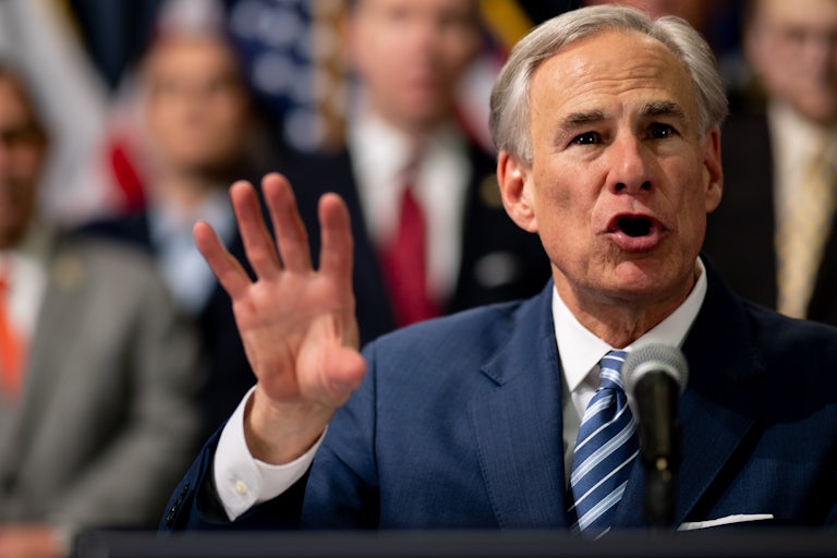 Texas Governor Greg Abbott speaks and gestures with his hand in the air