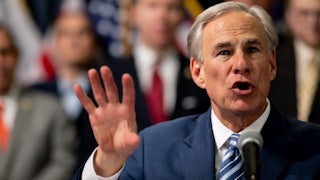 Texas Governor Greg Abbott speaks and gestures with his hand in the air