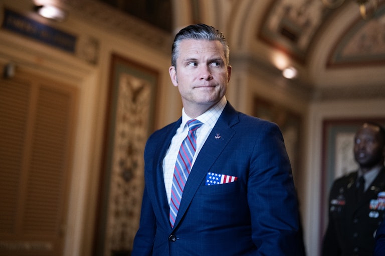 Defense Secretary Pete Hegseth looks to the side while walking in the Capitol