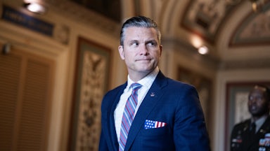 Defense Secretary Pete Hegseth looks to the side while walking in the Capitol