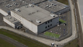 An aerial view of detainees outdoors at an ICE center.