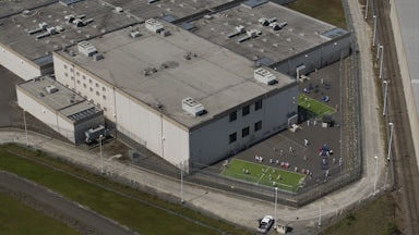 An aerial view of detainees outdoors at an ICE center.