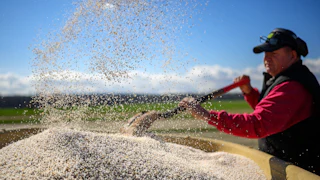 Farmer Bill Collins prepares to spread fertilizer