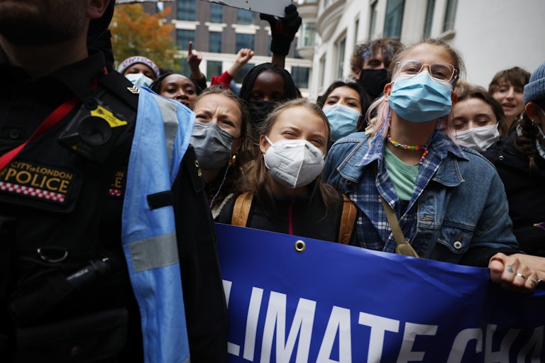 Climate protesters chant while masked.