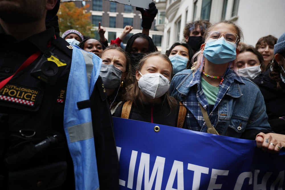 Climate protesters chant while masked.