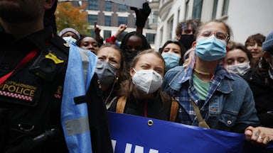 Climate protesters chant while masked.