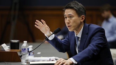 TikTok CEO Shou Zi Chew testifies before a mic. He raises his right hand.