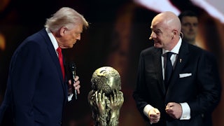 Donald Trump and FIFA President Gianni Infantino stand on stage with the FIFA Peace Prize between them