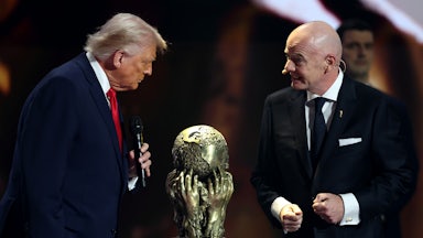 Donald Trump and FIFA President Gianni Infantino stand on stage with the FIFA Peace Prize between them
