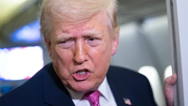 Donald Trump speaks to reporters on Air Force One