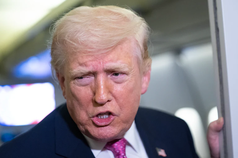 Donald Trump speaks to reporters on Air Force One