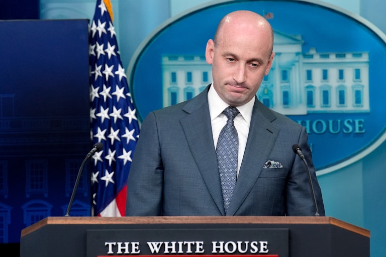 Deputy White House Chief of Staff Stephen Miller looks down while standing at the podium during a press briefing