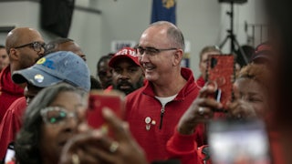 Shawn Fain smiles, surrounded by others.