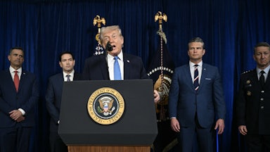 Trump speaks at the presidential podium while CIA Director John Ratcliffe, Secretary of State Marco Rubio, Defense Secretary Pete Hegseth, and Chairman of the Joint Chiefs of Staff General Dan Caine stand behind him in a row.