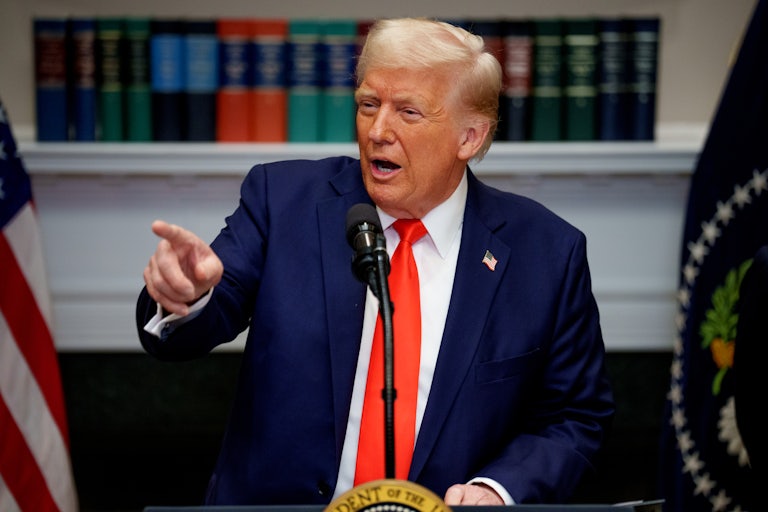 Donald Trump points while speaking at a podium