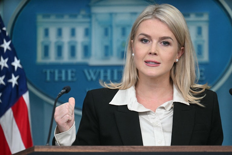 Karoline Leavitt gestures while speaking at the podium during a White House press briefing