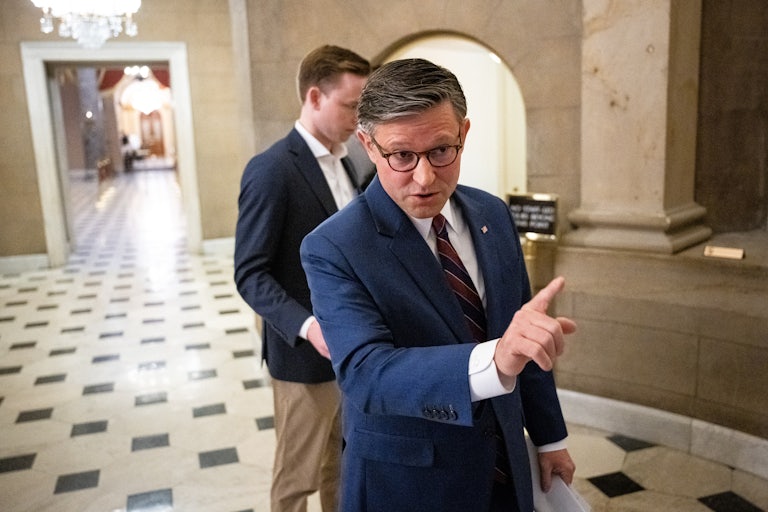 House Speaker Mike Johnson points an accusatory finger at someone (not pictured) in the Capitol.
