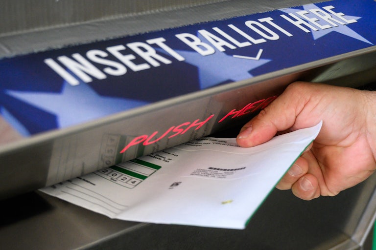 Someone puts a ballot in a drop box in Pennsylvania