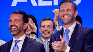 Donald Trump Jr. and Eric Trump smile and clap after ringing the Nasdaq opening bell.