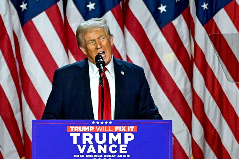 Donald Trump speaks at a podium