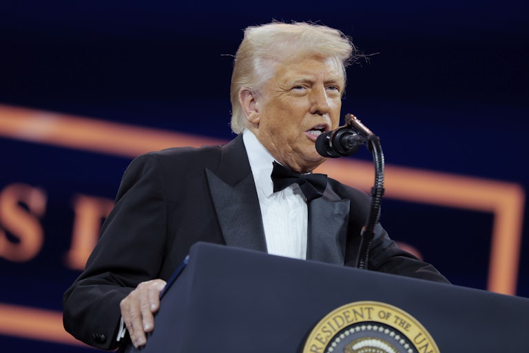 Donald Trump speaks at a podium during the National Republican Congressional Committee dinner