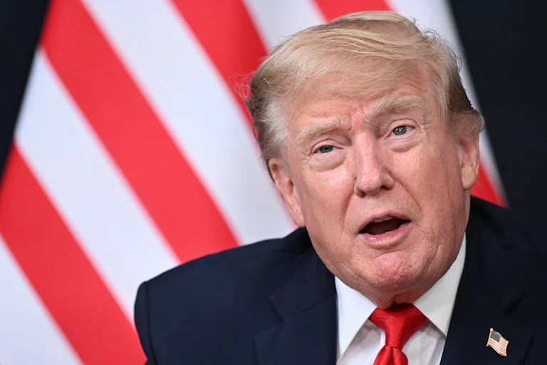 Trump opens mouth in front of US flag