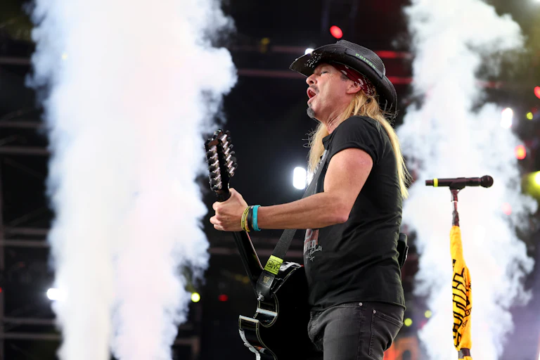 Musician Bret Michaels plays the guitar and sings
