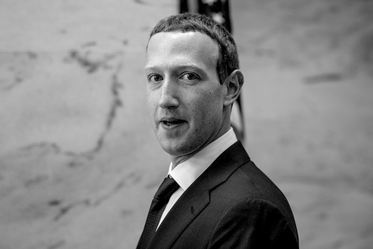 A black-and-white photograph of Facebook CEO Mark Zuckerberg