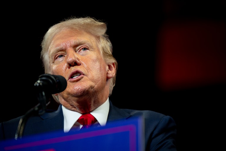 Donald Trump speaks into a mic