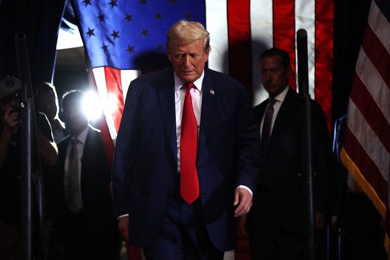 Donald Trump looks down as he walks at a campaign event