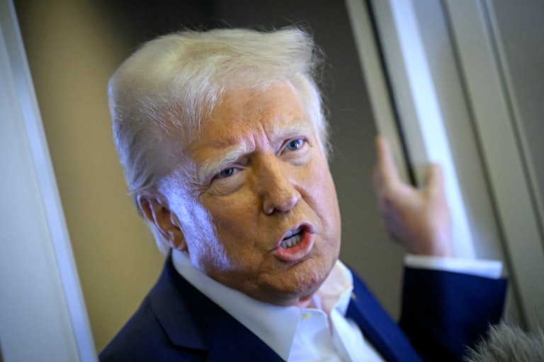 Donald Trump speaks to reporters on Air Force One