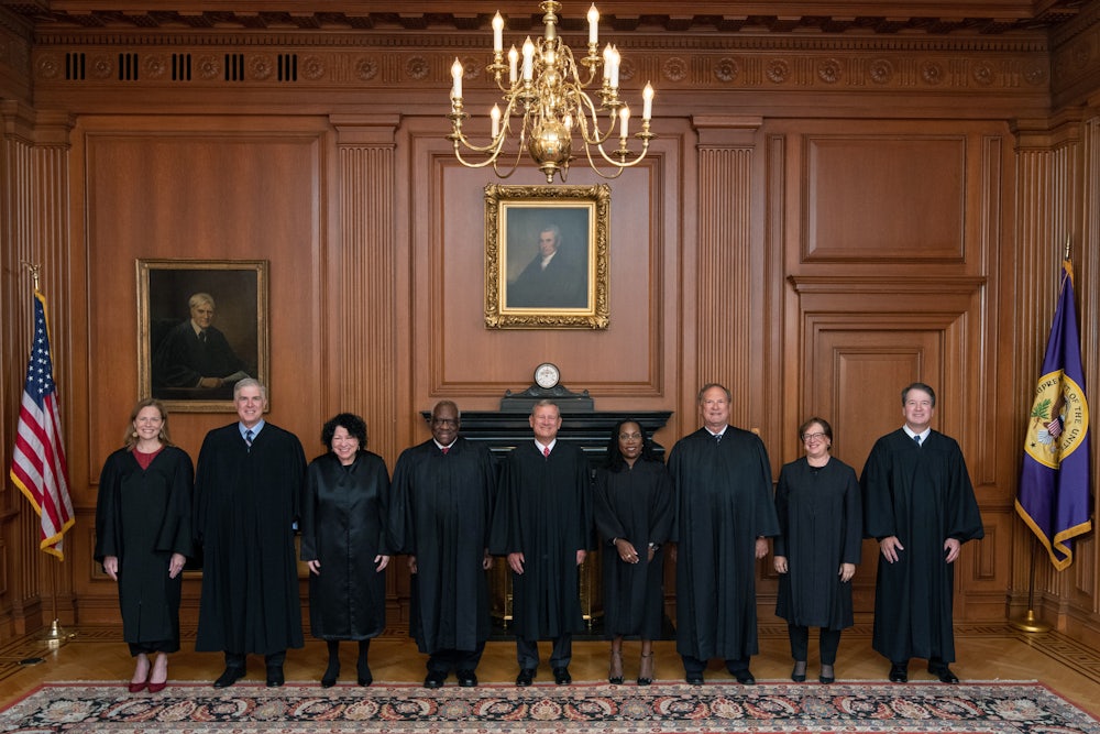 Members of the Supreme Court pose in the Justices Conference Room prior to the formal investiture ceremony of Associate Justice Ketanji Brown Jackson.