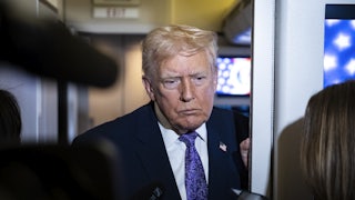 Donald Trump speaks to reporters aboard Air Force One.