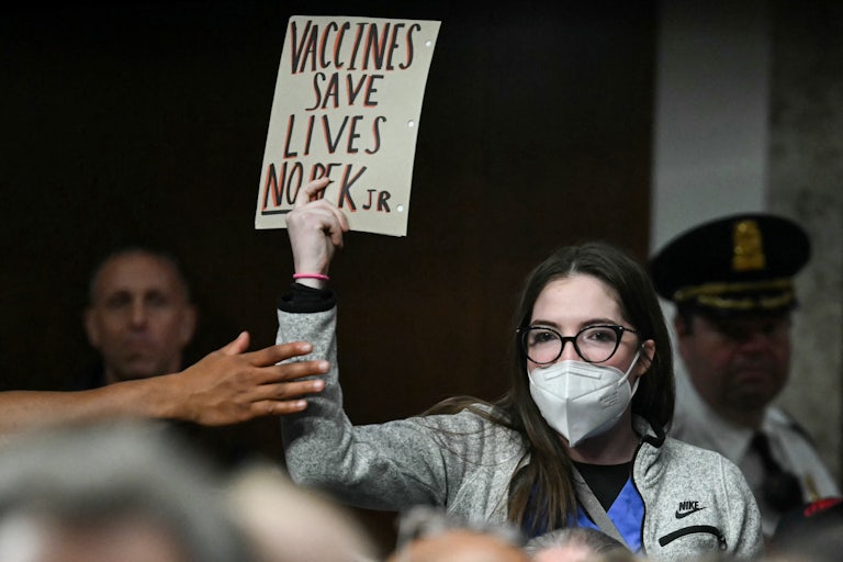 A protester holds up a pro-vaccine sign during Robert F. Kennedy Jr.’s Senate hearing