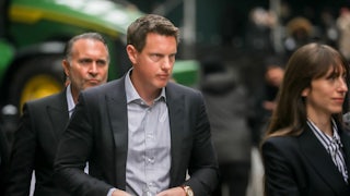 Paramount CEO David Ellison walks in a group of people.