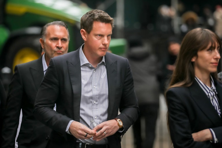 Paramount CEO David Ellison walks in a group of people.