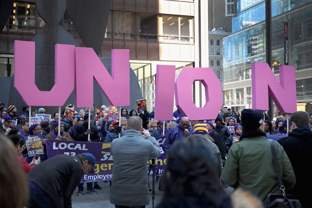 Members of the Service Employees International Union (SEIU) hold a rally in support of the American Federation of State County and Municipal Employees (AFSCME) union