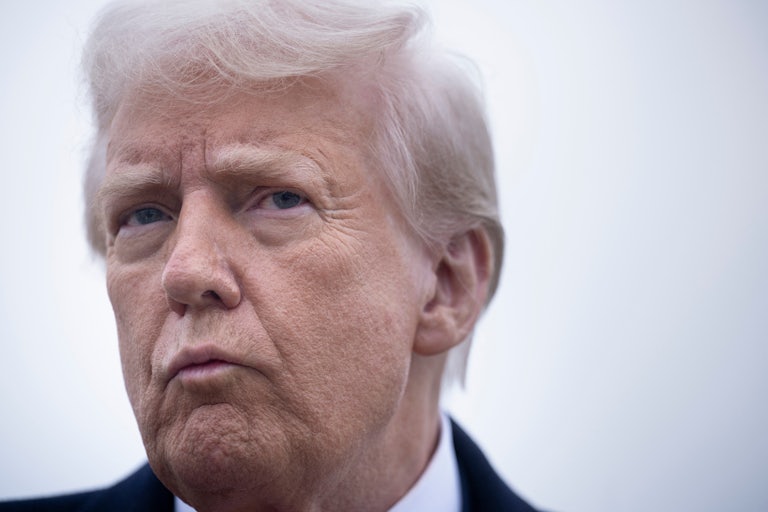 Donald Trump frowns while speaking to reporters