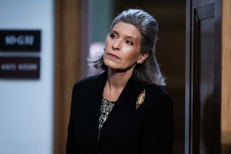 Senator Joni Ernst walks into a Senate hearing