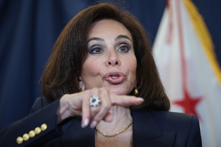 Jeanine Pirro gestures while speaking at a press conference