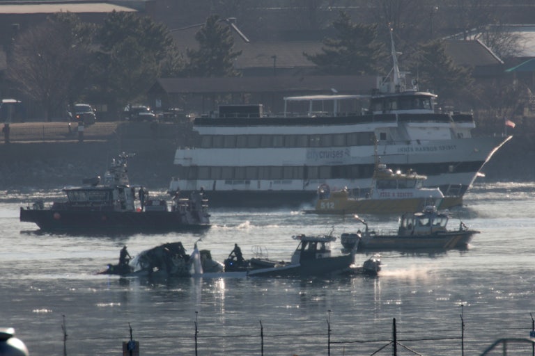 Emergency response crews search the Potomac River after a plane crash