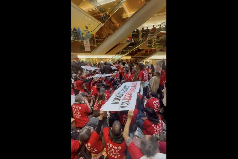 Jewish protesters hold a sit-in in Trump Tower, holding a banner that reads “Opposing Fascism Is a Jewish Tradition” and wearing shirts that read "Jews Say Stop Arming Israel."