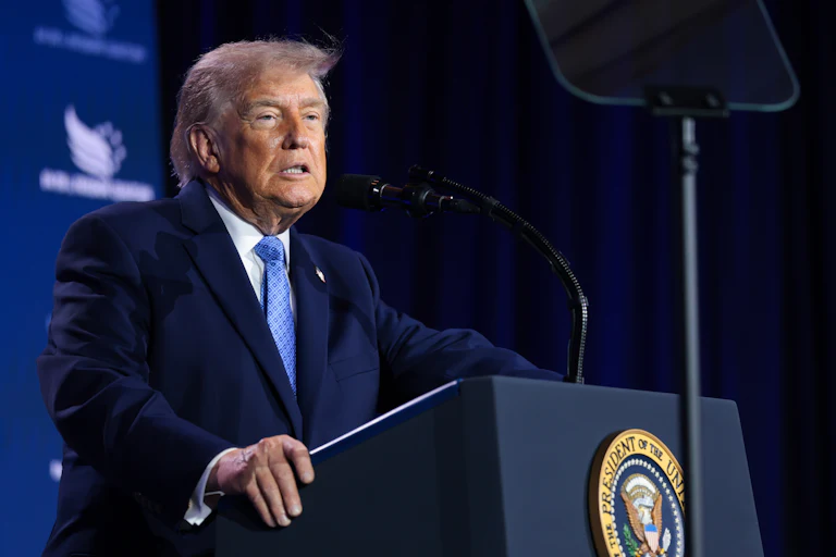 Donald Trump grimaces while standing at a podium
