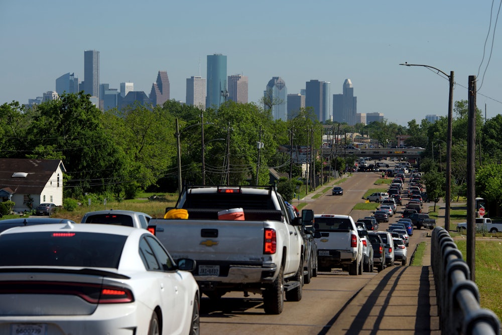 Cars wait in a line on a highway.