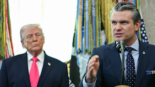 Pete Hegseth stands on the right behind a lecturn with the presidential seal, with President Trump standing behind him to his left.