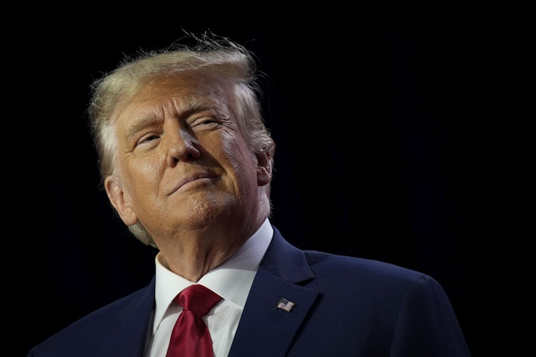 Donald Trump smiles and looks up to the side