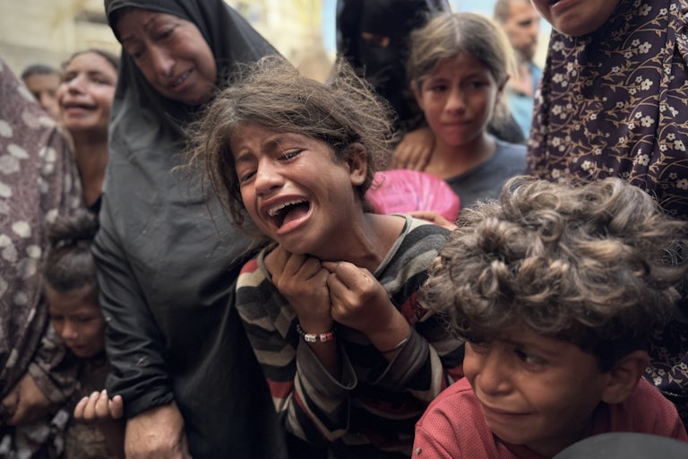 A Palestinian child cries after an Israeli airstrike on Gaza.