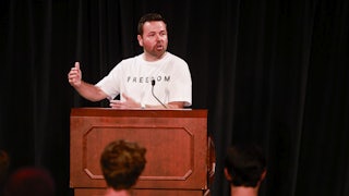 Indiana Lt. Governor Micah Beckwith speaks at a podium while wearing a Freedom t-shirt.
