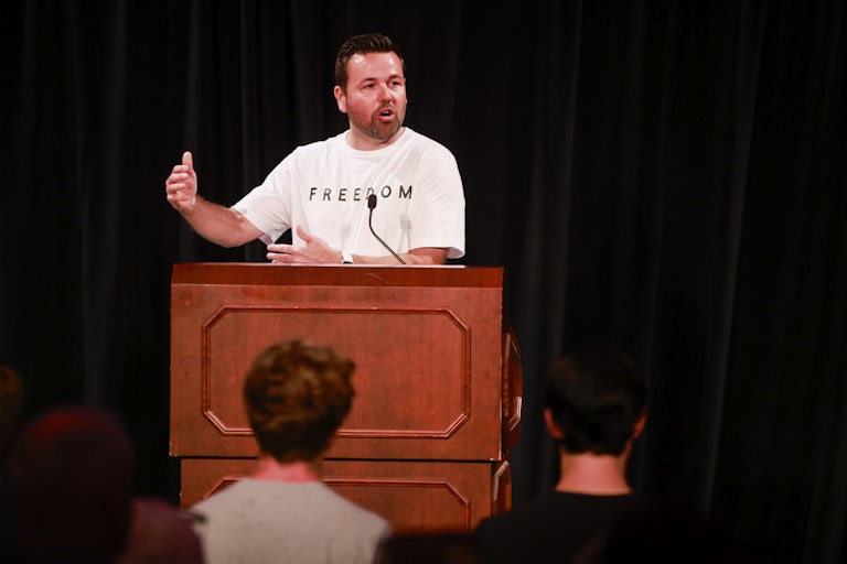 Indiana Lt. Governor Micah Beckwith speaks at a podium while wearing a Freedom t-shirt.